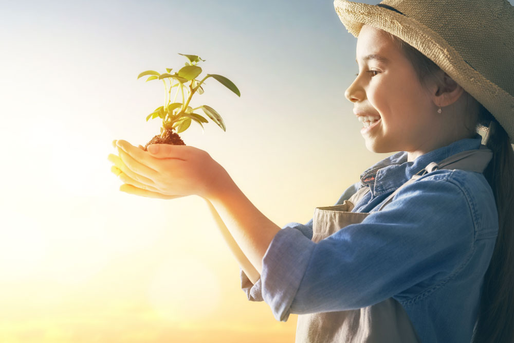 A child holding a plant